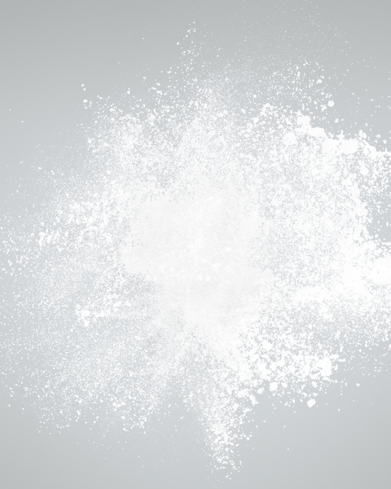 A spray of white granulated powder against a light background.