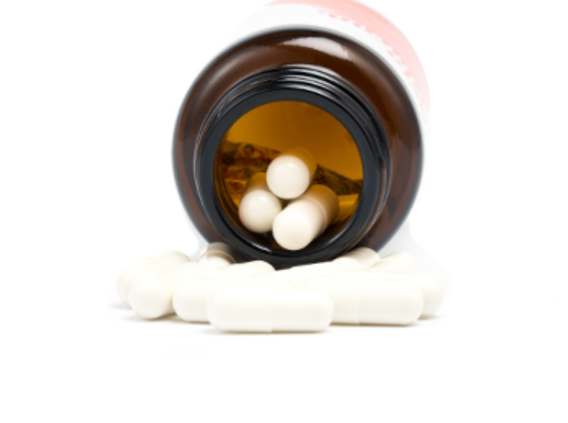 white pills with bottle on white background