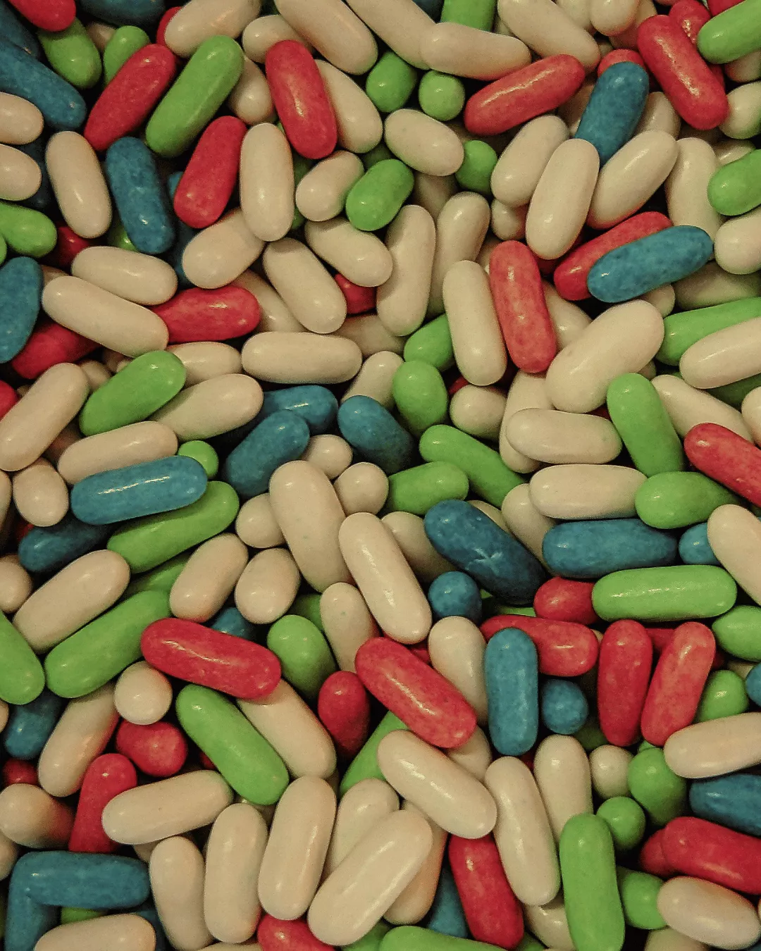 Slender oblong shaped coated tablets in a variety of colors.